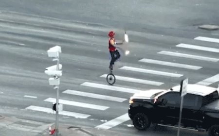 Fire-juggling unicyclist caught on camera blocking traffic in major roadway as police intervene