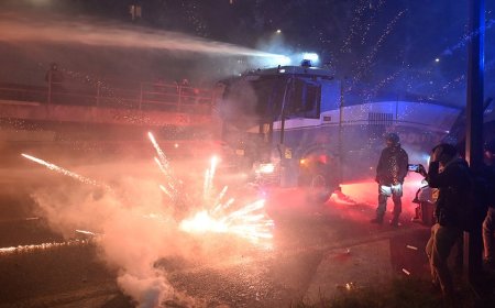 Fireworks fly as hooded protesters clash with police after Olympics open in Milan