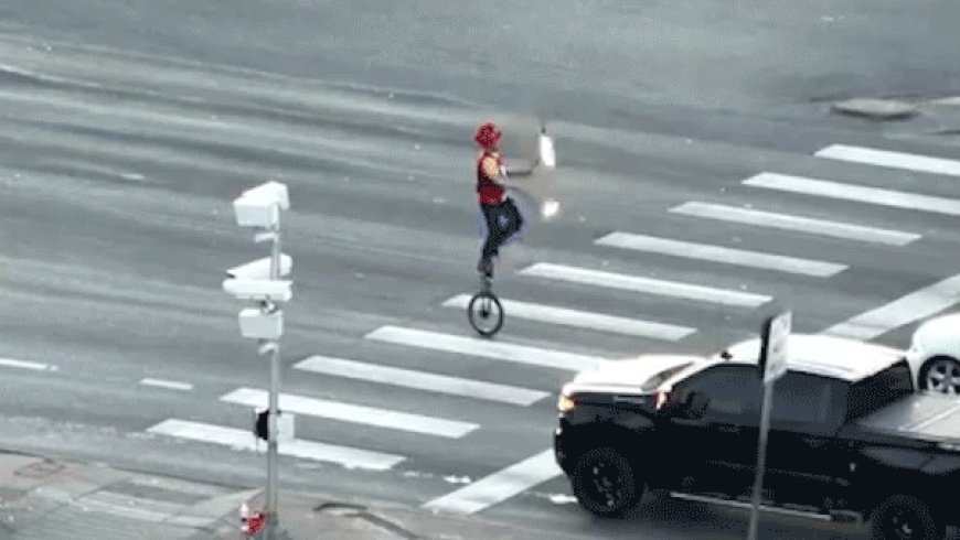 Fire-juggling unicyclist caught on camera blocking traffic in major roadway as police intervene