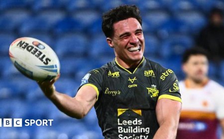 Leeds run riot at Huddersfield to go top