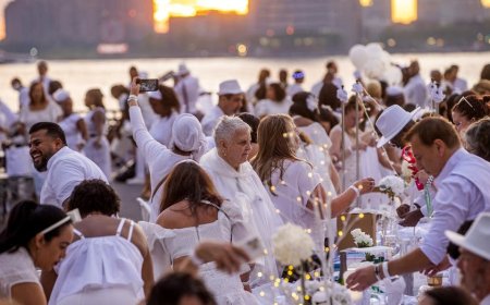 Dinner party has guests bringing tables, dressing in white and learning location last-minute
