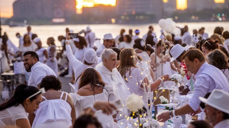 Dinner party has guests bringing tables, dressing in white and learning location at last minute